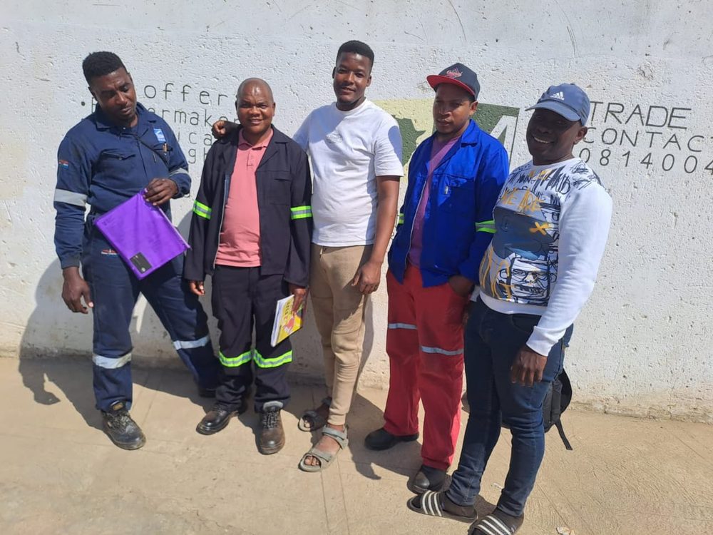 A group of trainees with their folders